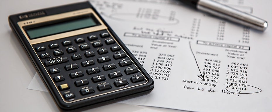black-calculator-near-ballpoint-pen-on-white-printed-paper-53621-1